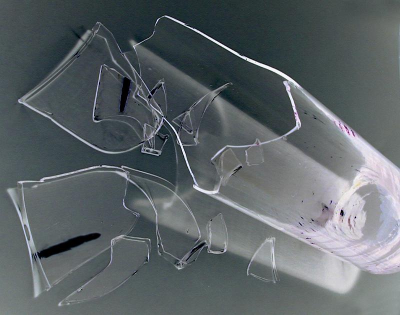 Free Stock Photo: Glass or tumbler shattered into sharp shards lying on a grey background