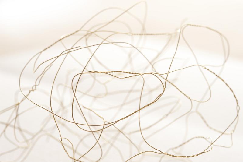 Free Stock Photo: Tangled golden picture hanging wire with blurry background and copy space for messy or confused concept