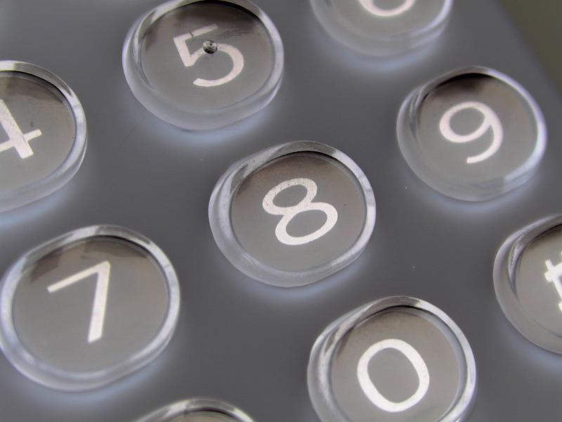 Free Stock Photo: Close up detail of a numerical keypad with raised translucent buttons and white numbers