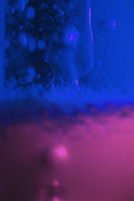 Free Stock Photo: Abstract background composed of blue and purple gel with some bubbles behind glass