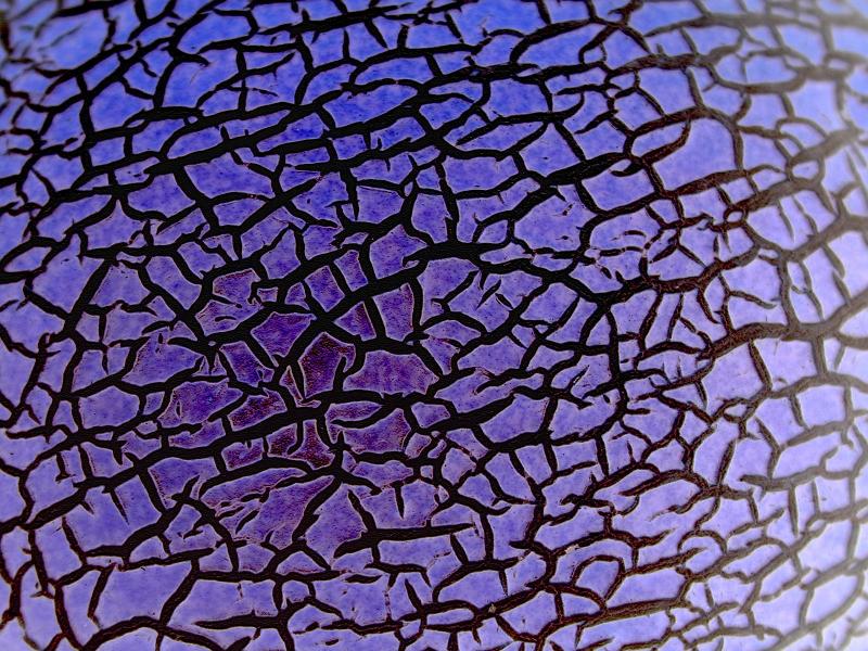 Free Stock Photo: Close up of black lined cracks on purple toned melon skin