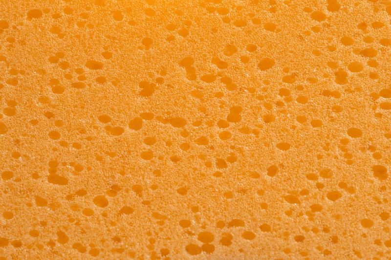 Free Stock Photo: Close up of textured orange sponge surface with dark pores