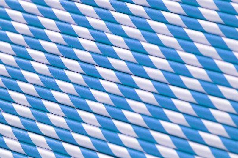 Free Stock Photo: Blue and white straws background pattern with the straws laid side by side in a diagonal orientation for a colorful spiral pattern