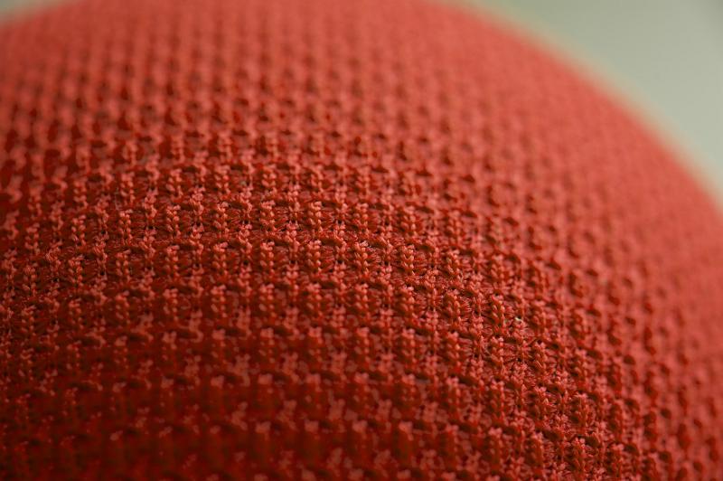 Free Stock Photo: Cropped macro close up view on tightly knit orange fabric over sphere or ball as abstract texture with copy space