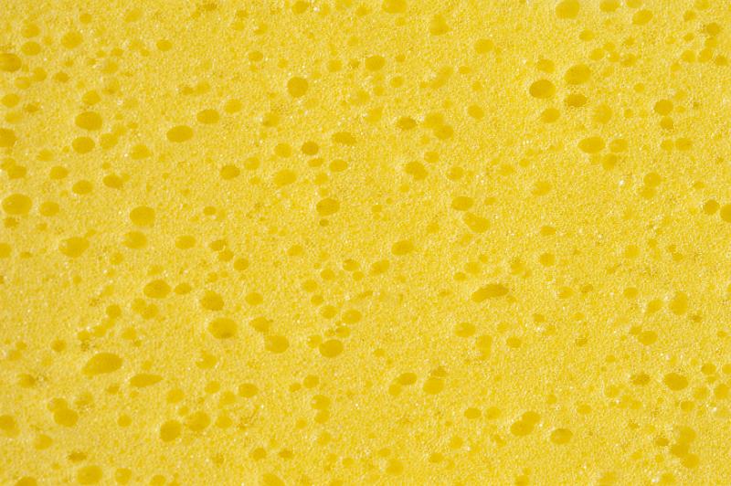 Free Stock Photo: Extreme macro top down close up on various sized porous holes in yellow sponge as full frame background with copy space