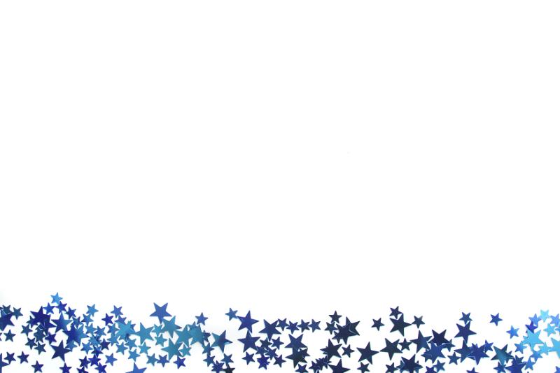 Free Stock Photo: Blue star festive border with a myriad of small stars scattered along the bottom of the frame isolated on white with copy space