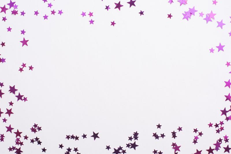 Free Stock Photo: Colorful pink glitter star frame for Christmas, birthday or anniversary themed celebrations with center copy space on white for your greeting or advertising