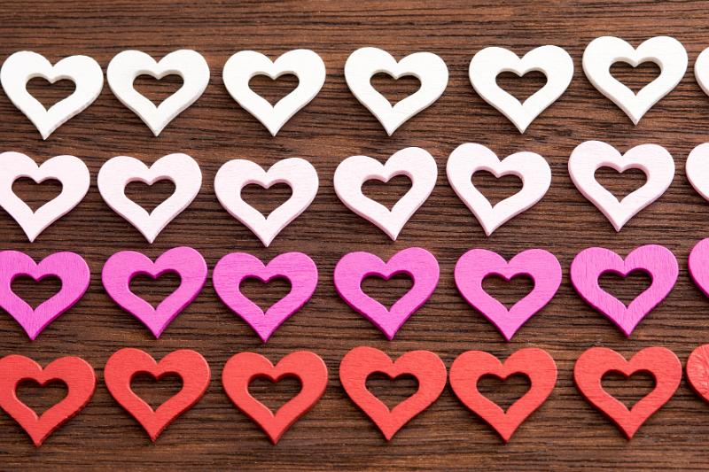 Free Stock Photo: gradient coloiured rows of hearts on a wooden surface