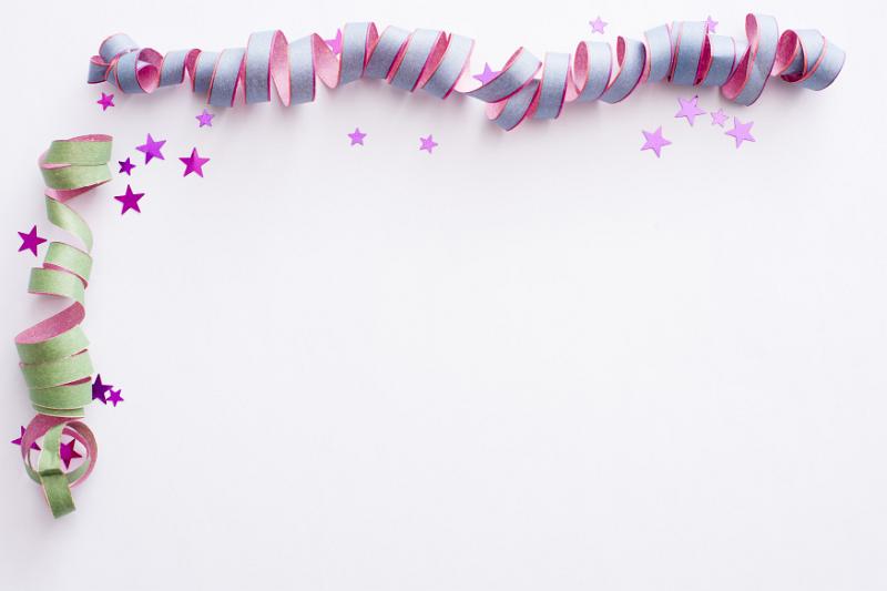 Free Stock Photo: Party streamer corner border decoration with spiral twirled streamers and scattered stars on white with copy space
