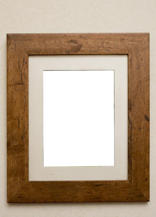 Free Stock Photo: Empty plain rustic wooden picture frame with a beige colored interior mount board and copy space on a neutral beige background
