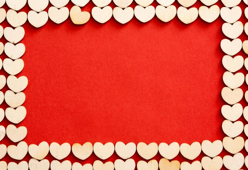 Free Stock Photo: Romantic wooden hearts frame on a red background with copy space for your wedding, anniversary or Valentines concept
