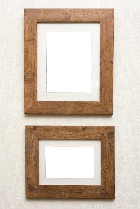 Free Stock Photo: Two empty rustic wooden frames with neutral mount card inserts hanging on an off white wall ready for your artwork of photo