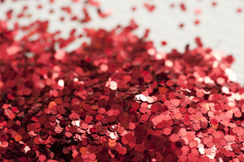 Free Stock Photo: Close up view on pile of bright red circular sparkling glitter objects with background out of focus