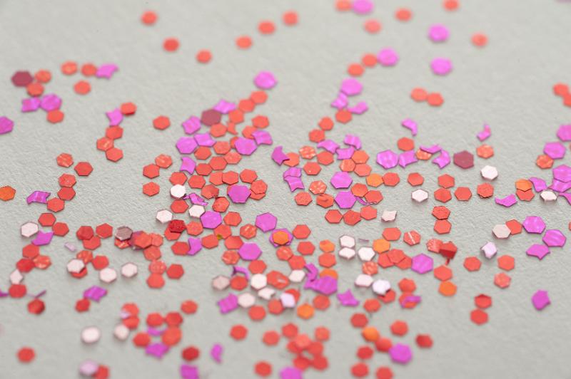 Free Stock Photo: red and pink glitter scattered on a white background