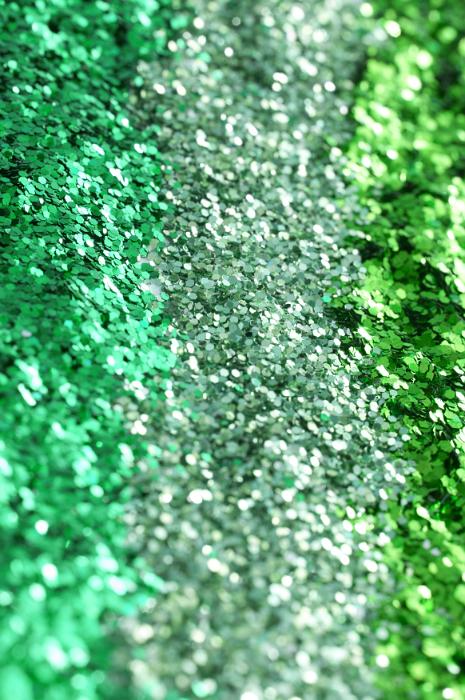 Free Stock Photo: Shiny green glitter background texture in shades of green and emerald arranged in vertical lines for a restive or craft concept