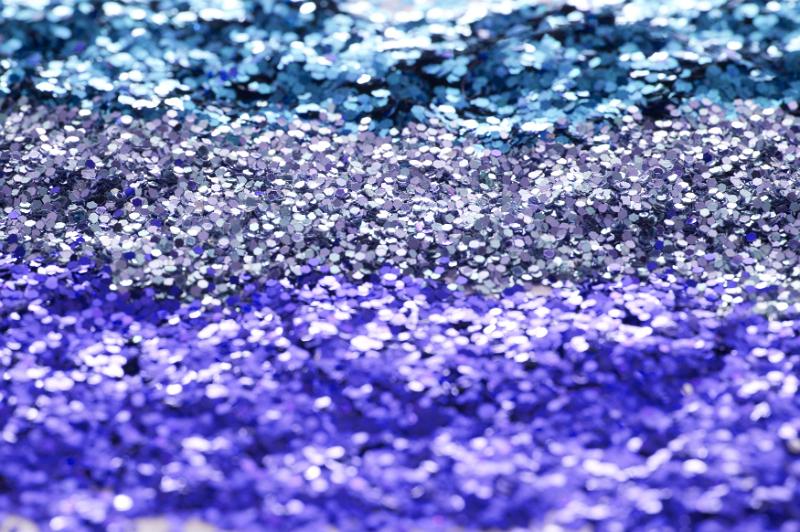 Free Stock Photo: Abstract background texture of colorful sparkling blue glitter in three different shades with focus to the center band for use as a festive or craft background