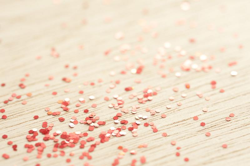 Free Stock Photo: red coloured glitter particles scattered on a wooden background