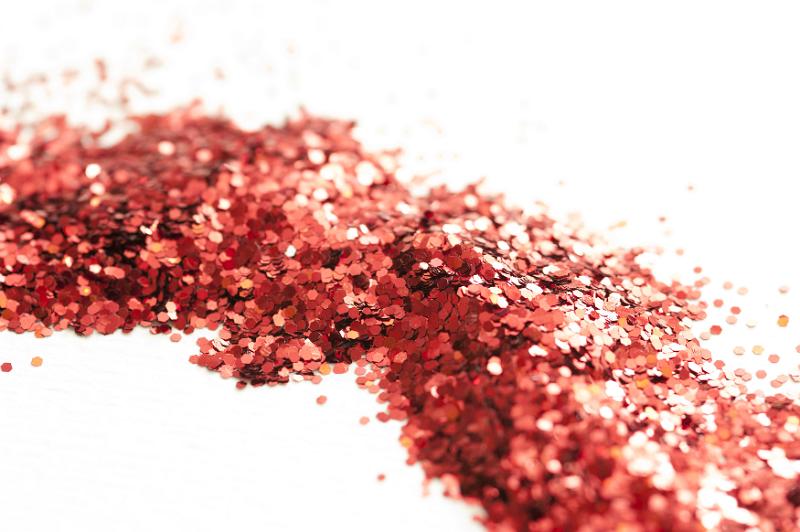 Free Stock Photo: Trail of Red Glitter Across White Studio Surface - Abstract Background of Sparkling Red Glitter