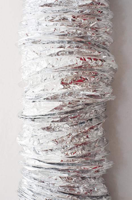 Free Stock Photo: Silver cylindrical duct or tube covered in foil for heat retention in a close up view over a grey background