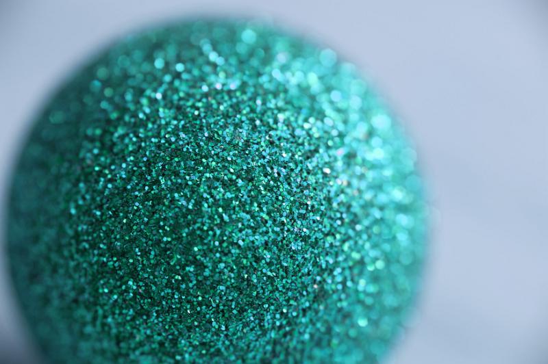 Free Stock Photo: Close Up of Teal Glitter Ornament Ball Sparkling in Diffuse Selective Focus in Studio with Copy Space