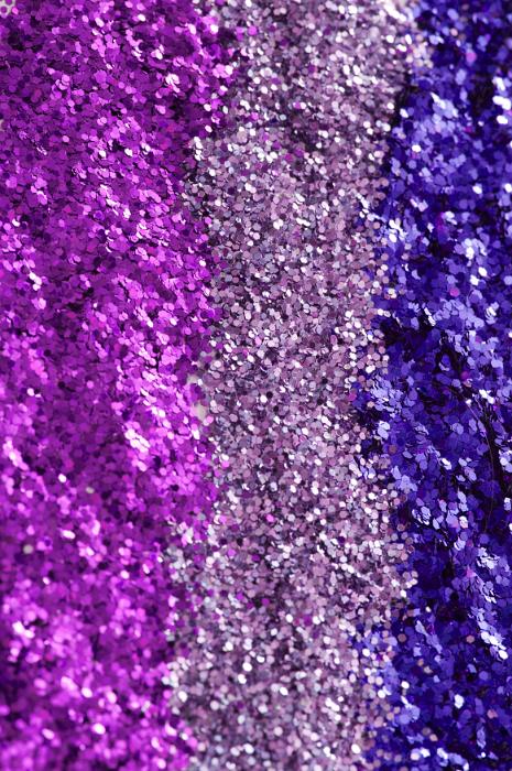 Free Stock Photo: Festive glitter background texture with vertical bands of magenta, pink and blue glitter in a full frame view