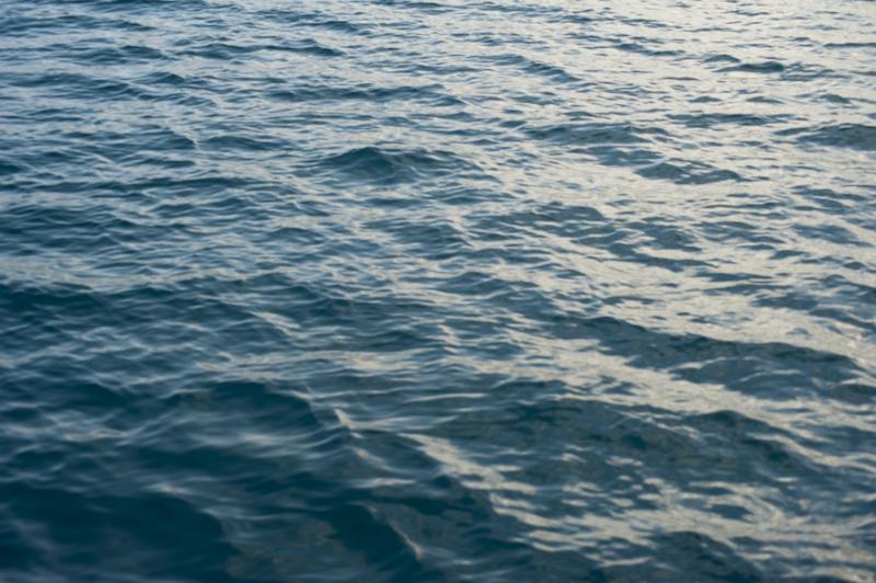 Free Stock Photo: Empty full frame angled view of calm ocean or lake waves rippling on surface with light reflected