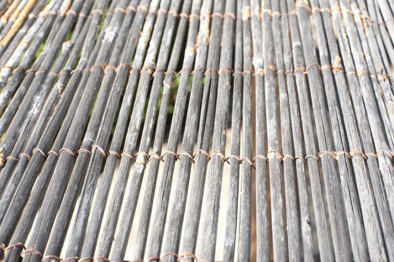 Free Stock Photo: Angled view on stringed dry canes as fence with copy space for concept about living with nature