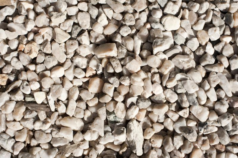 Free Stock Photo: Background texture of light colored stone chips or gravel in an overhead view of a surface layer