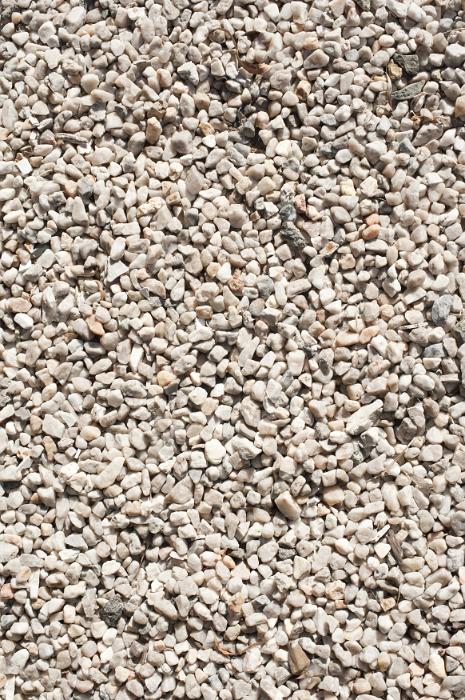 Free Stock Photo: Simple white and gray chipped stone, gravel or kitty litter on an even level with copy space