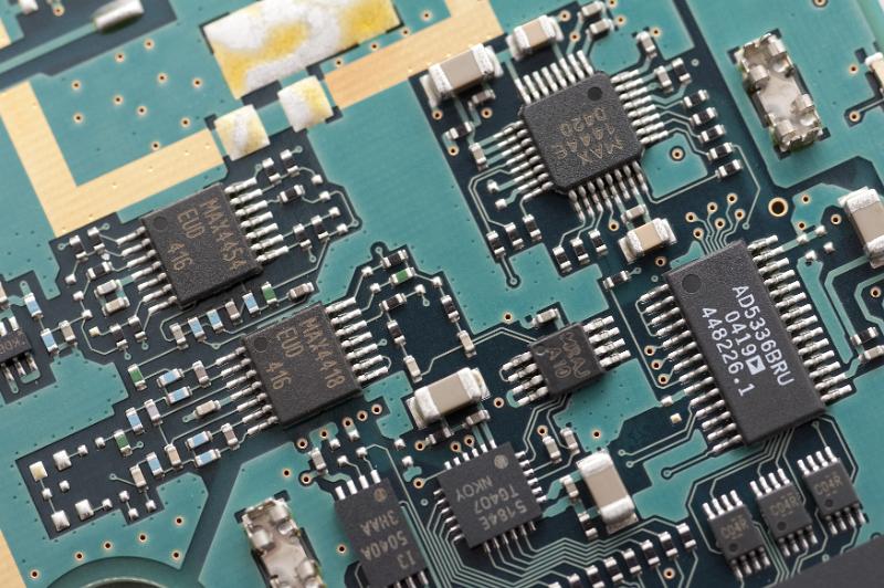 Free Stock Photo: Green printed circuit board detail with soldered transistors and microprocessors from above at tilted angle