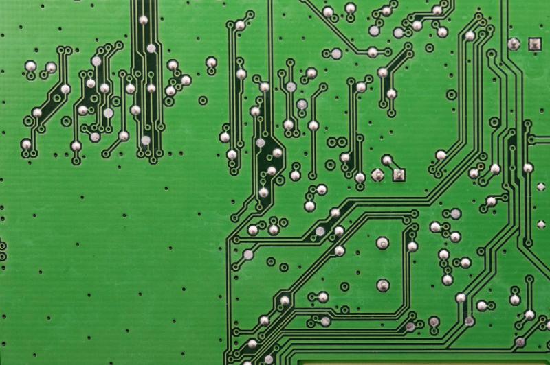 Free Stock Photo: Top down view on reverse side of green circuit board with soldered points and wires
