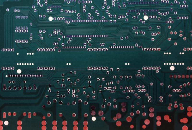 Free Stock Photo: Extreme close up overhead view of circuit board with many soldered parts and components