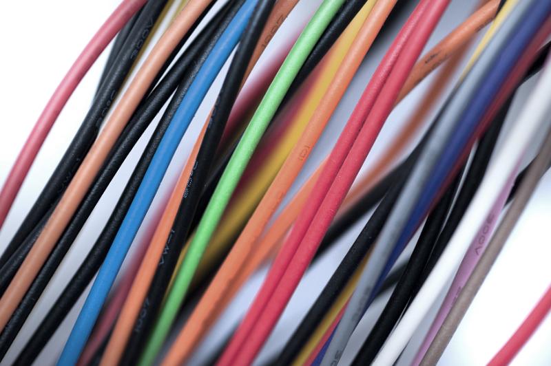Free Stock Photo: Colorful collection of low voltage wires covered in orange, red, green, blue , brown, white and black plastic in a close up diagonal view