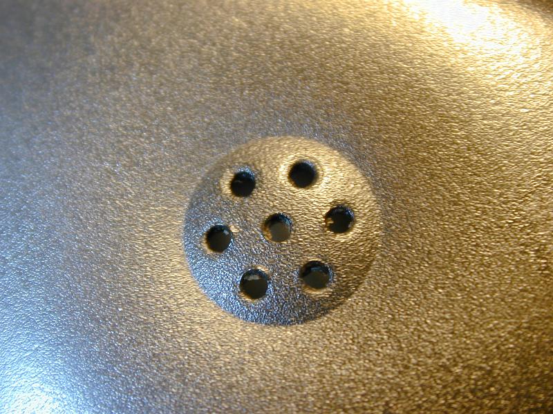 Free Stock Photo: Macro close up on telephone earpiece section speaker with seven little holes in the middle