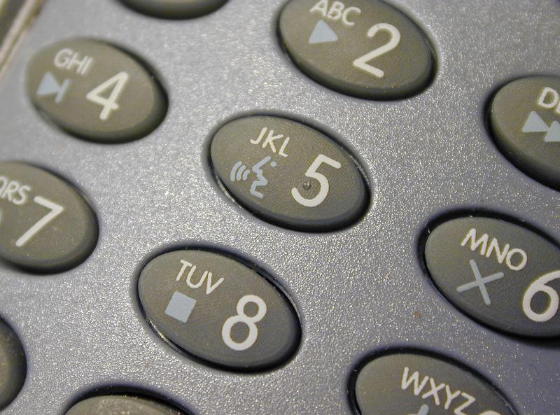 Free Stock Photo: Top down angled close up on oval shaped telephone keypad with media control symbols