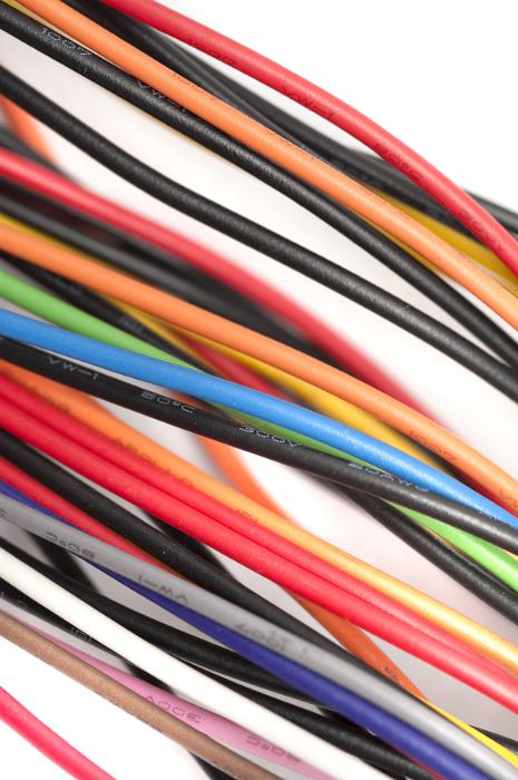 Free Stock Photo: Colorful bunch of plastic coated wires in the colors of the spectrum arranged diagonally across the frame in a random jumble over white