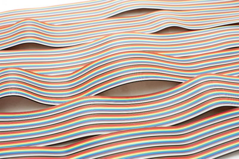Free Stock Photo: Staggered lines of bent wire ribbons stretching across white surface for concept about electronics