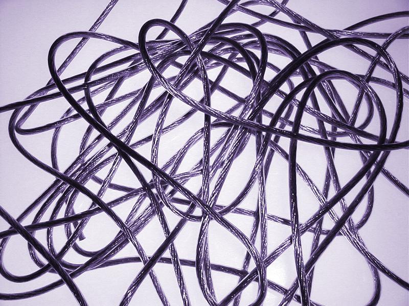 Free Stock Photo: A tangle of thin wires over a white background with purple toning viewed from above forming an abstract pattern and texture