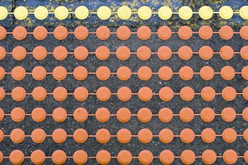 Free Stock Photo: Overhead extreme close up view of pavement surface with orange and yellow bumps