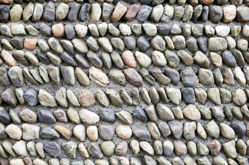Free Stock Photo: Rows of smooth stones stuck in cement or gravel for background concept about nature and order