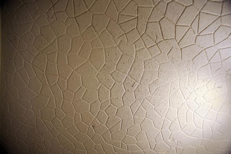 Free Stock Photo: Abstract background composed of a cracked tan ceiling with a highlight in the corner