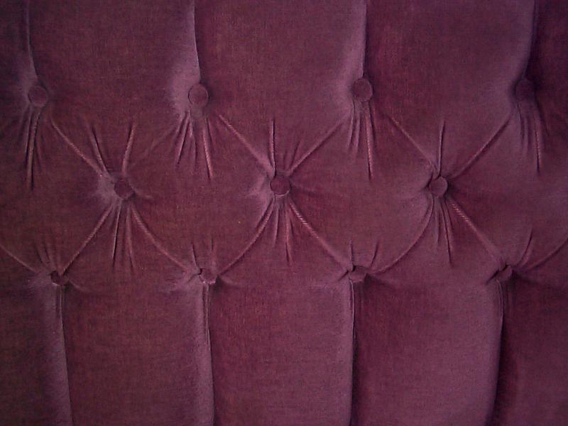 Free Stock Photo: Tightly cropped close up on dark red sofa back cushion with felt type upholstery