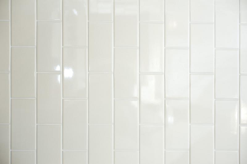 Free Stock Photo: Background texture of long white vertical shiny ceramic tiles with light reflections on a wall, full frame view