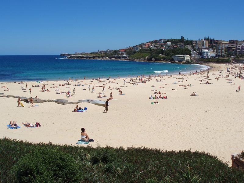 Free Stock Photo: Scenic view on a hot summer day of the golden sands of Coogie Beach, Sydney, Australia dotted with sun worshippers and tourists and a calm blue ocean with no surfers