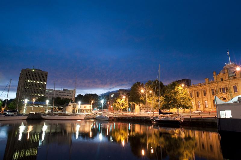 Free Stock Photo: Night time view of Hobart Docks,Australia with the lights of the illuminated waterfront buildings reflected in the calm water, copyspace in the sky