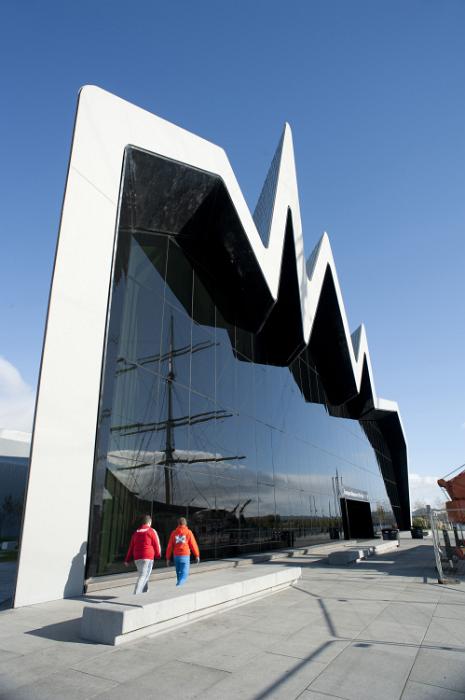 Free Stock Photo: Distinctive modern exterior facade of the Riverside Museum, Glasgow. Scotland with its zigzag design and large window reflecting a tall ship in the harbour