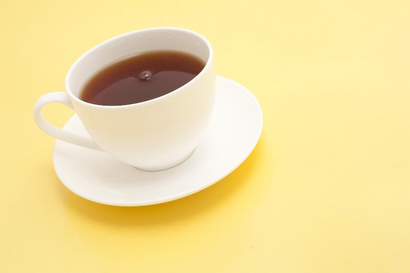 Free Stock Photo: England marches on cups of tea: Freshly brewed cup of hot refreshing black tea served in a white cup and saucer on a pale yellow background with copyspace