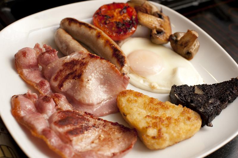 Free Stock Photo: Nothing says heartattack better than a Full English breakfast served on a plate with egg, bacon, sausage, hash browns, tomato and mushroom for a hearty start to the day