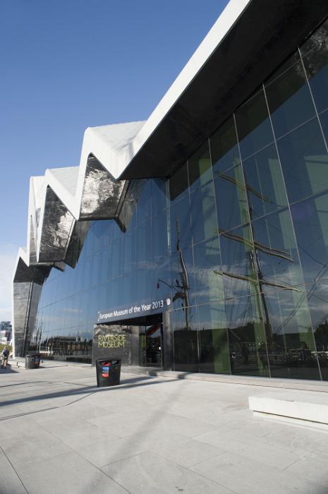 Free Stock Photo: Exterior facade of the new Riverside Museum in Glasgow, Scotland, part of the Museum of Transport, with a tall ship in the harbour reflected in the large glass windows