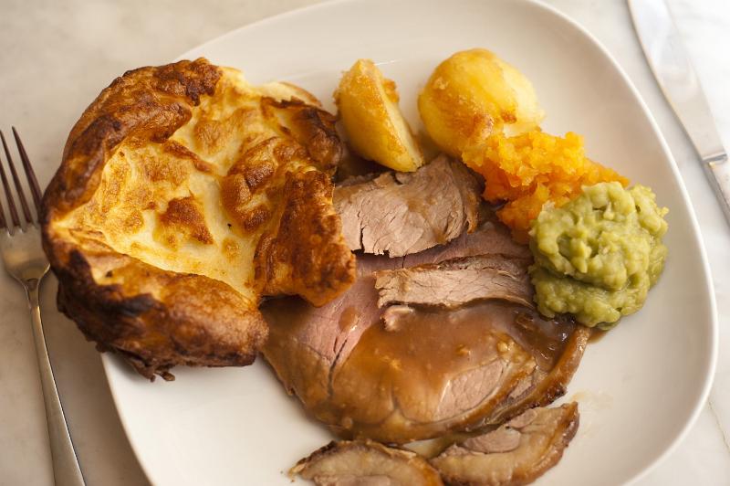 Free Stock Photo: Traditional English roast beef dinner served with Yorkshire Pudding, vegetables and a rich gravy